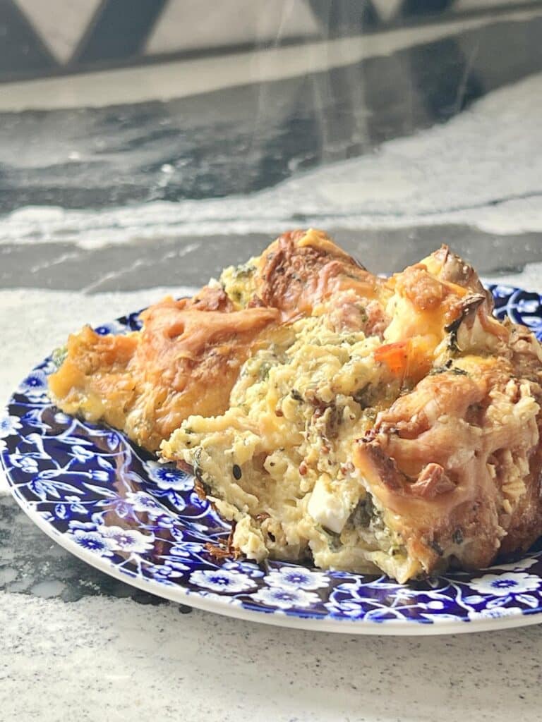 A portion of the overnight everything bagel breakfast casserole bake on a plate.