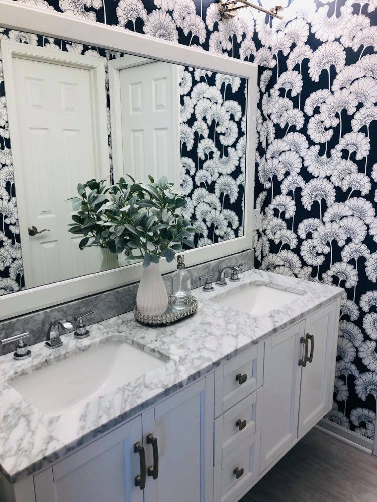 
A bathroom with fan floral wallpaper.