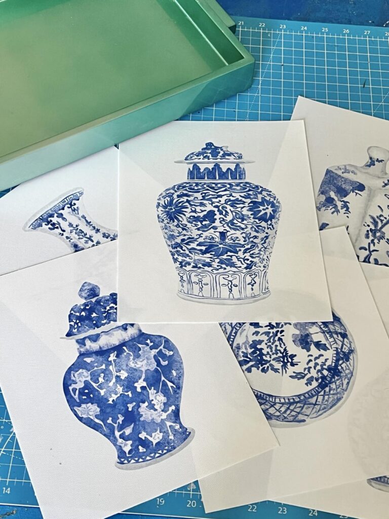 A pile of blue and white chinoiserie art prints.