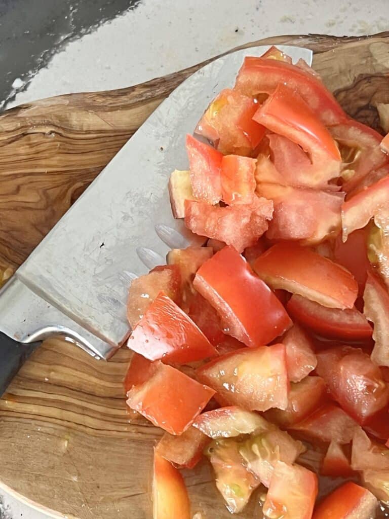 Chopping tomatoes.