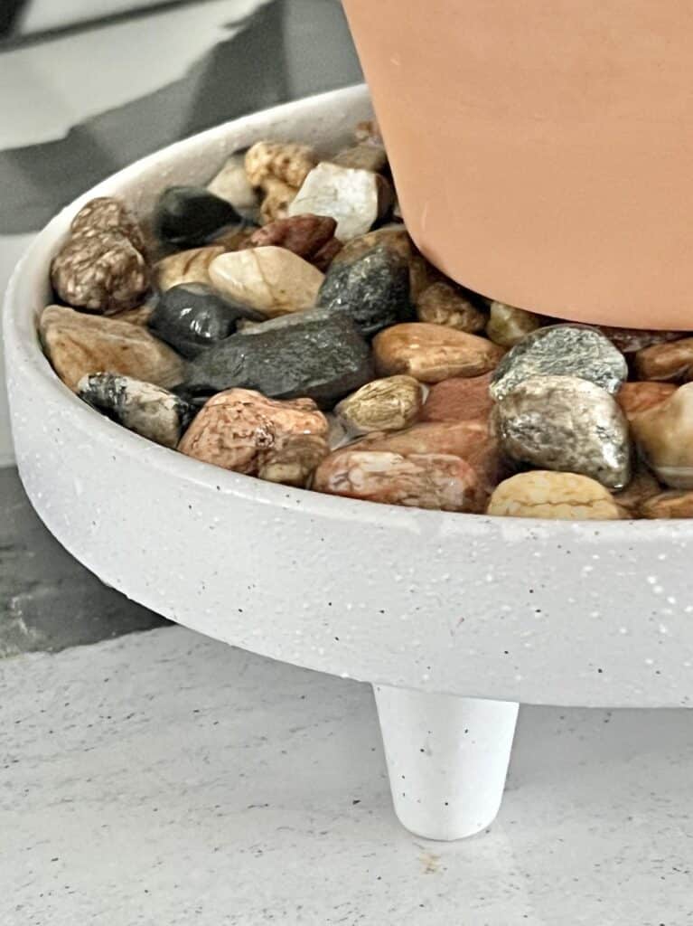 River rock in a pebble tray for plants.