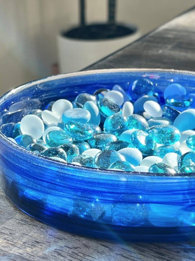 Blue glass stones in aa glass tray.