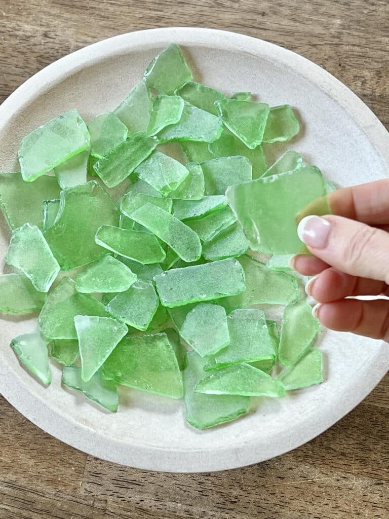 Green beach glass used for pebble tray for plants.