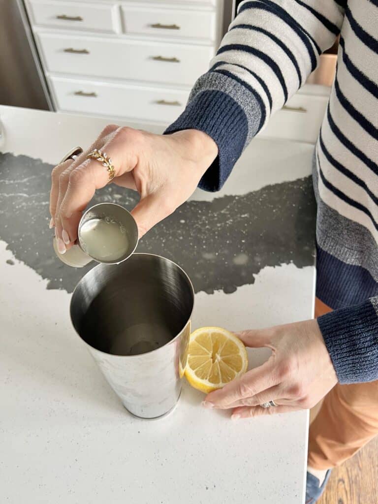 Pouring lemon to make a French 76.