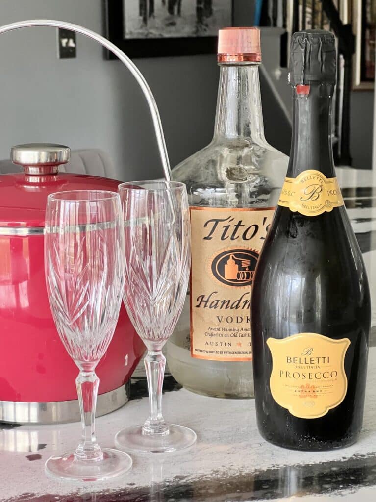 A bottle of vodka and a bottle of Prosecco to make a french 75 recipe with vodka