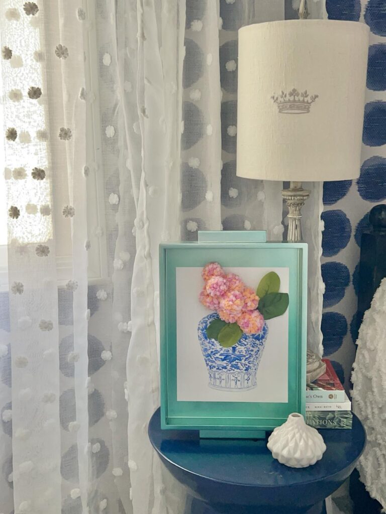 Displaying the DIY yarn pom pom wall decor on aa side table.