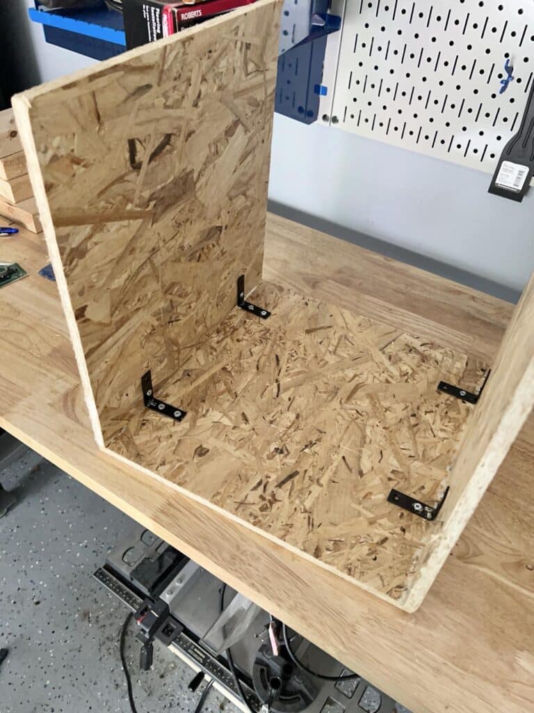 Three pieces of wood bracketed together to create a U shape.