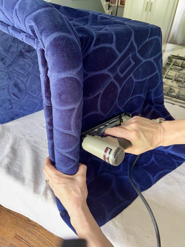 A staple gun used to staple a pool noodle into fabric.