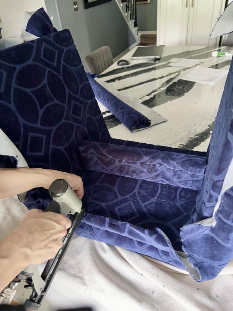 Stapling excess fabric.