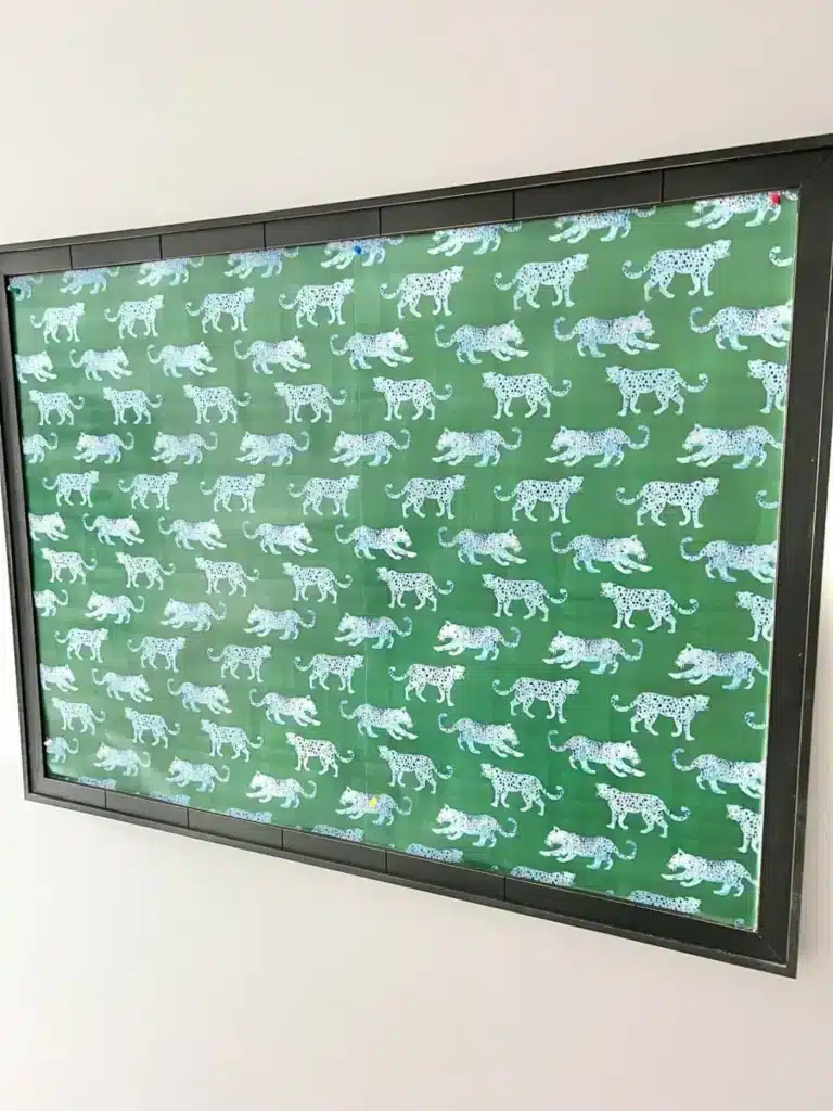 A wallpaper covered bulletin board.