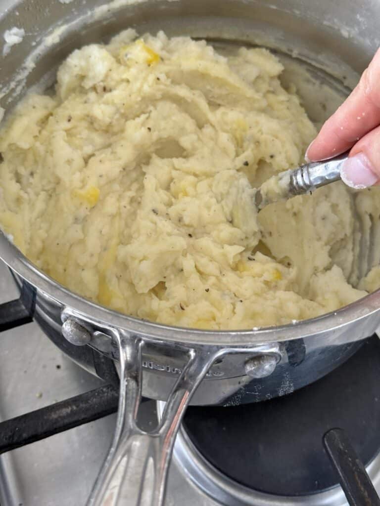 Mixing mashed poatoes for the shepherd's pie with beef.