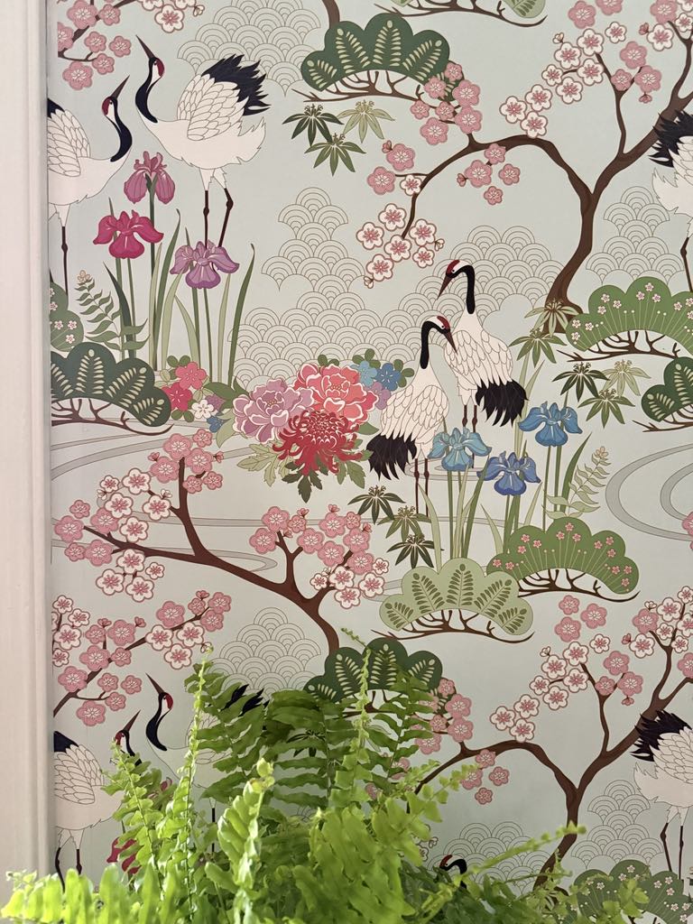 Chinoiserie style wallpaper in pink, blue, and green.