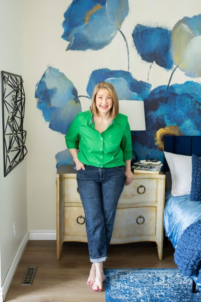 Woman wearing jean and preppy green button down shirt.