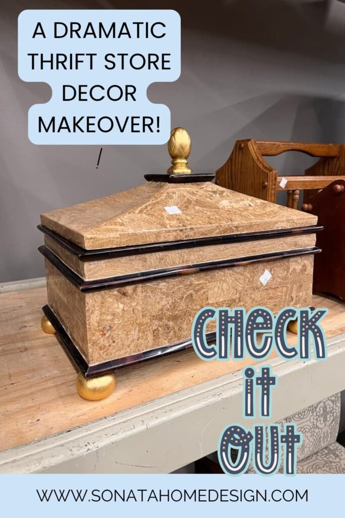 A thrift store box with gold lid ad gold bun feet.