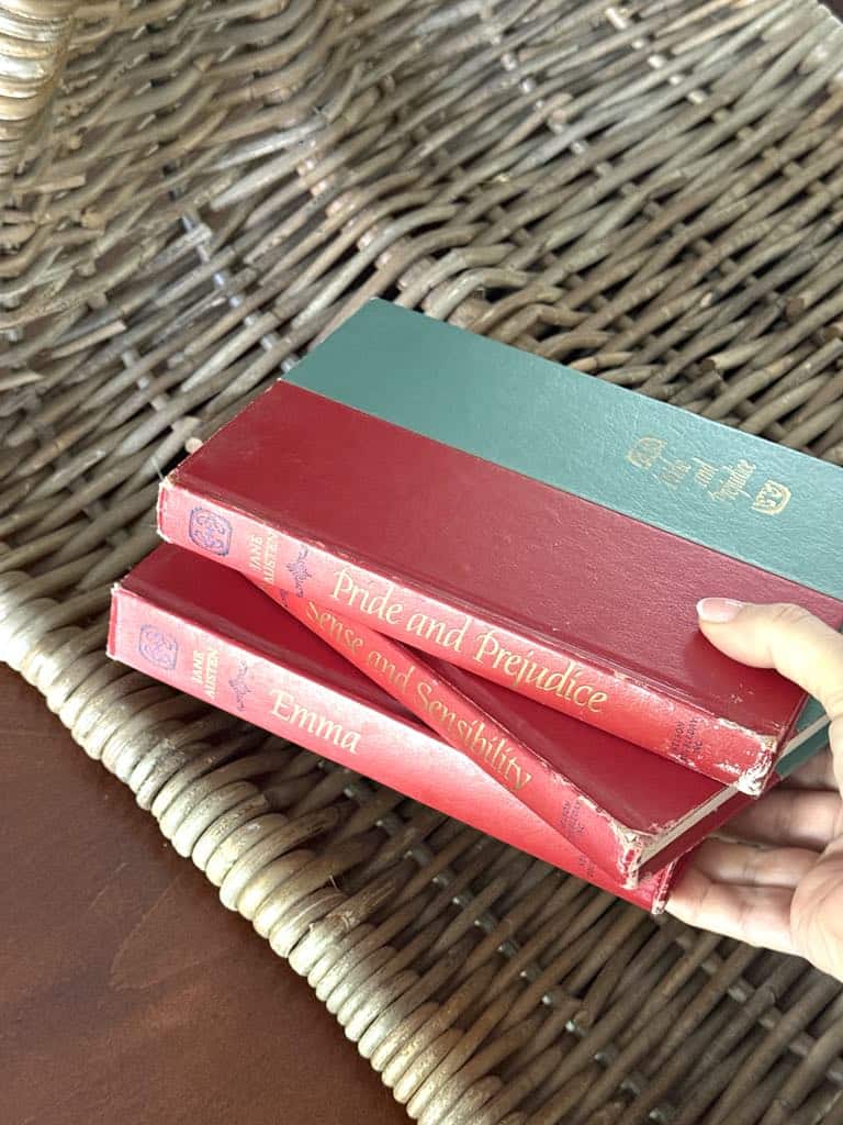 Three books by Jane Austen with red and blue covers.