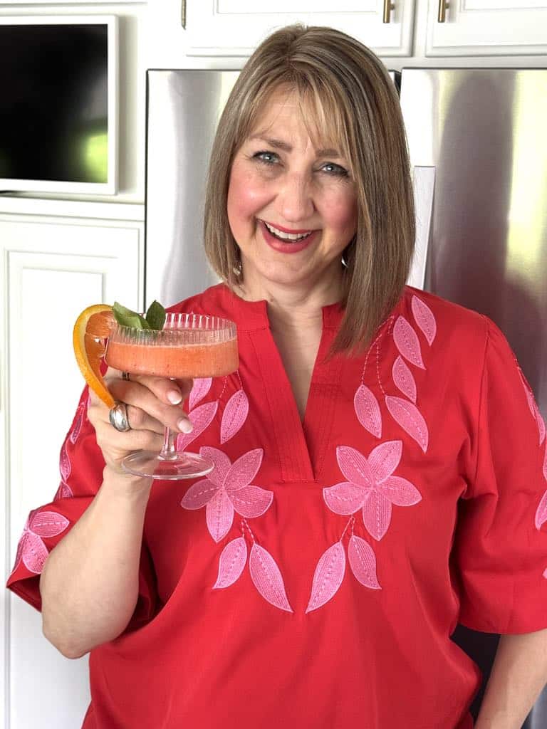 Woman holding a frozen aperol spritz.