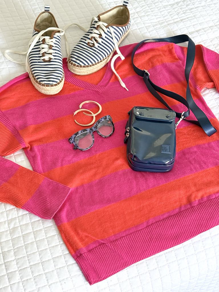 A preppy stripe sweater in pink and orange.