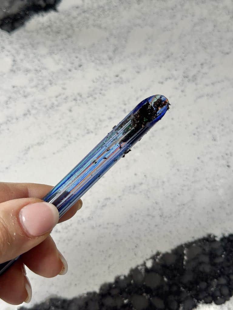 Dirt stuck in the bottom of a water globe stick.