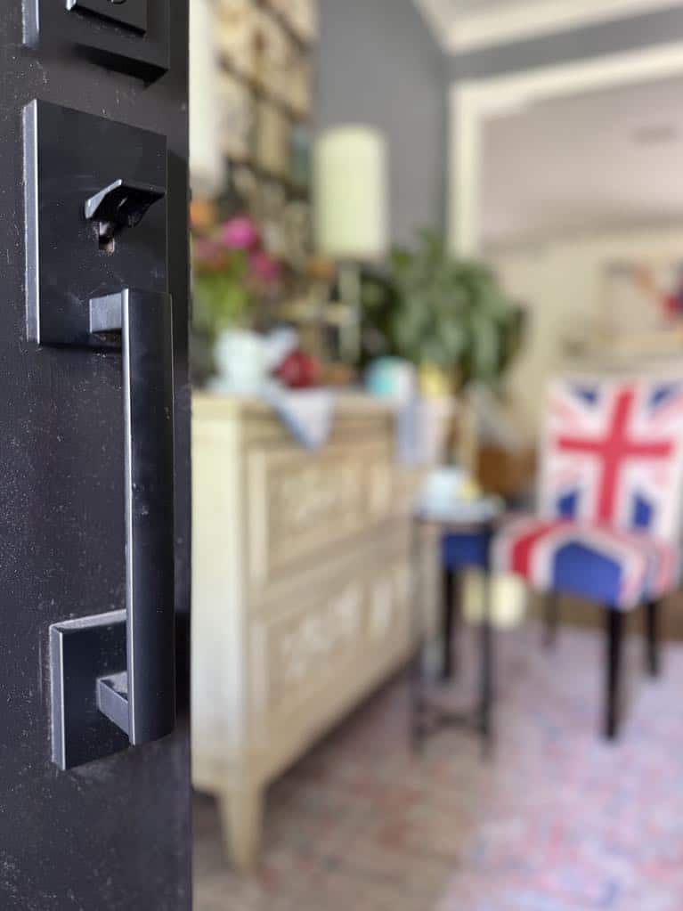 A front door opening into a foyer styled with a tea party tablescape.