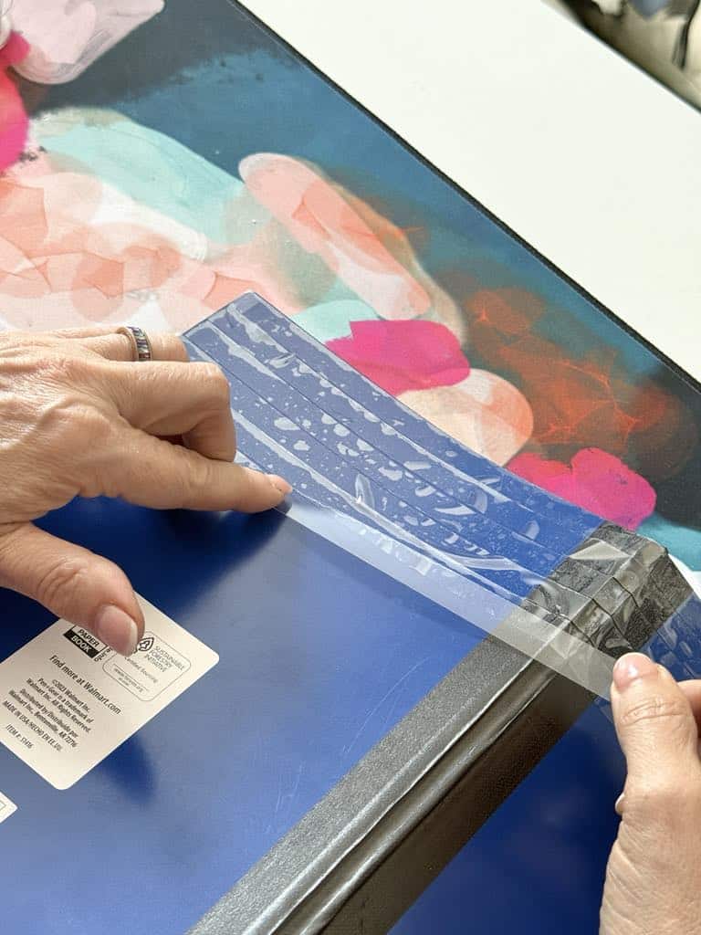 Placing double-sided tape on the outside of a notebook.