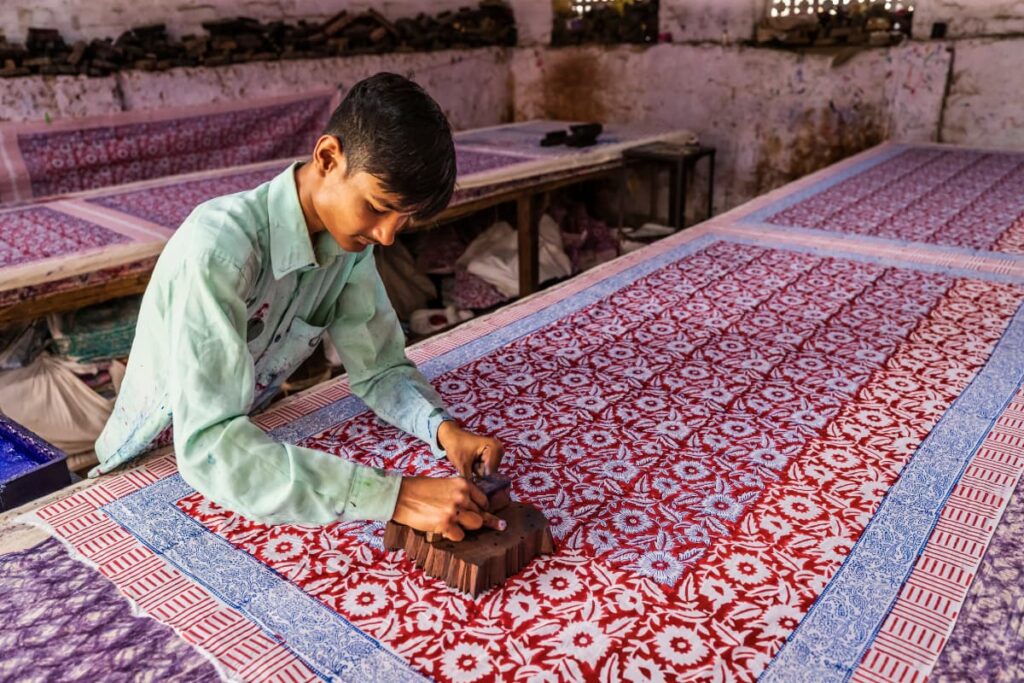 A man block printing fabric.
