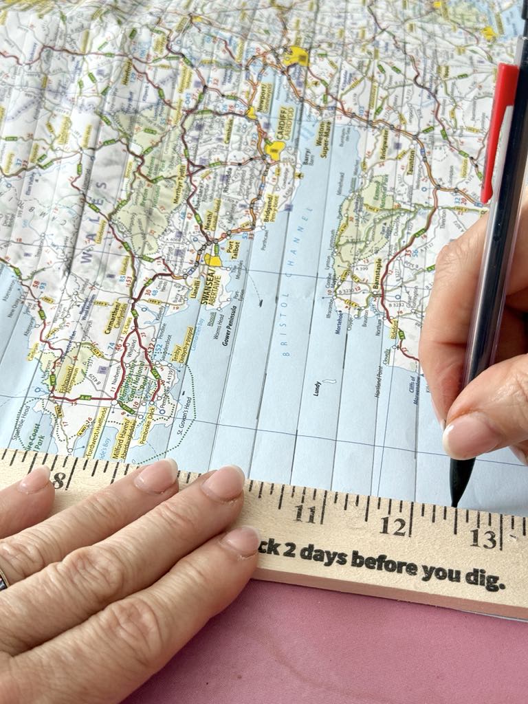 Marking half inch strips on a map for a DIY journal.