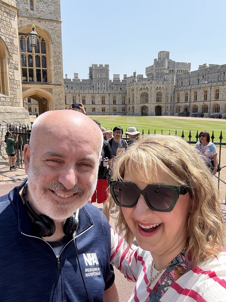 Man and woman standing in front of Windsor Castle.