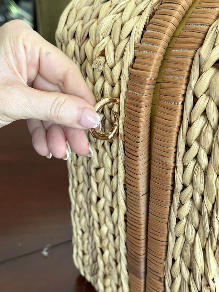 Hooking a gold O ring into the side of a thrifted picnic basket.