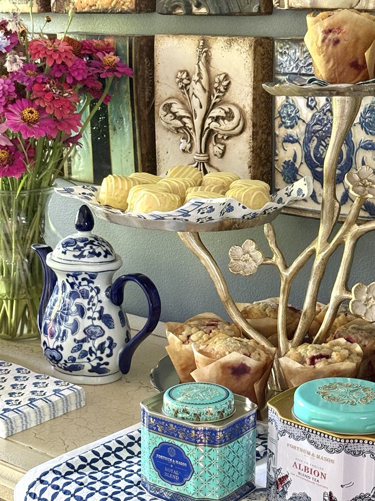 A tiered tray filled with lemon cakes and muffins as part of a tea party tablescape.
