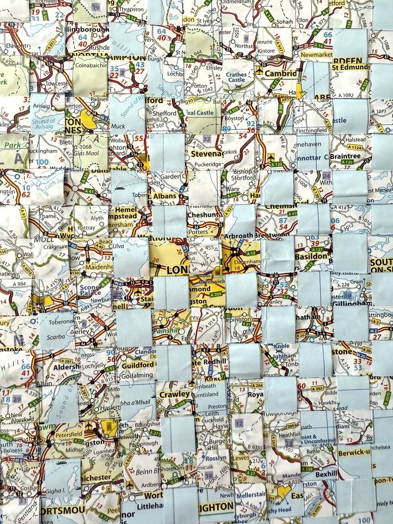 Woven pieces of a map for a travel journal diy.