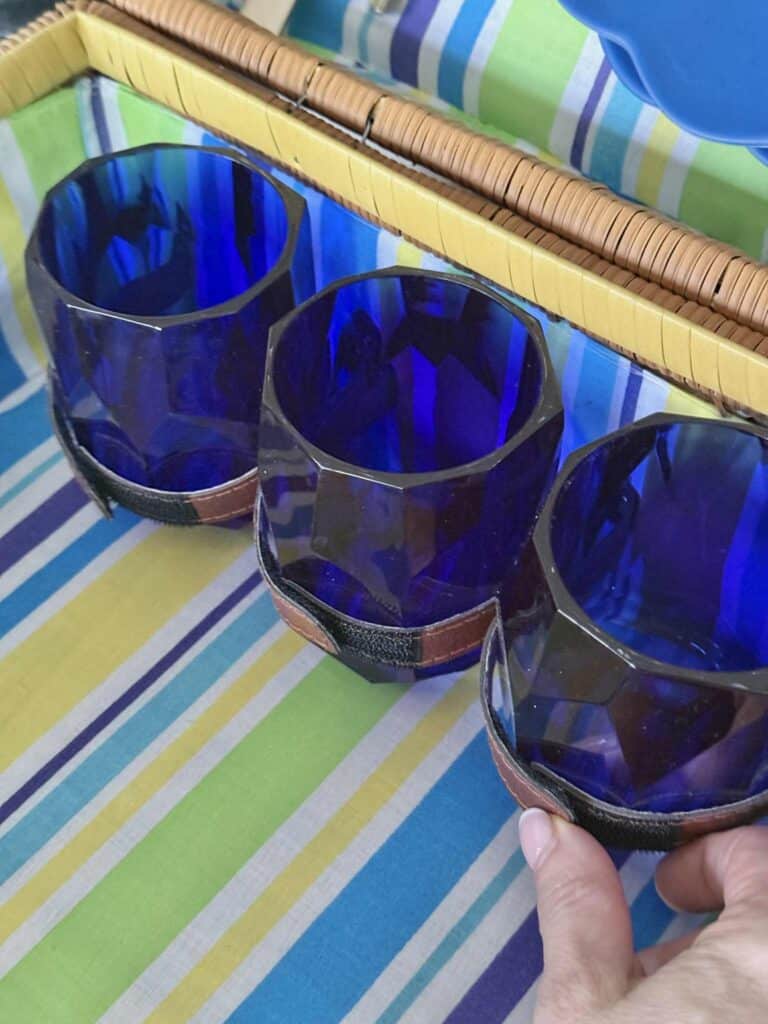 Cobalt blue melamine glasses anchored in a hamper with velcro straps.