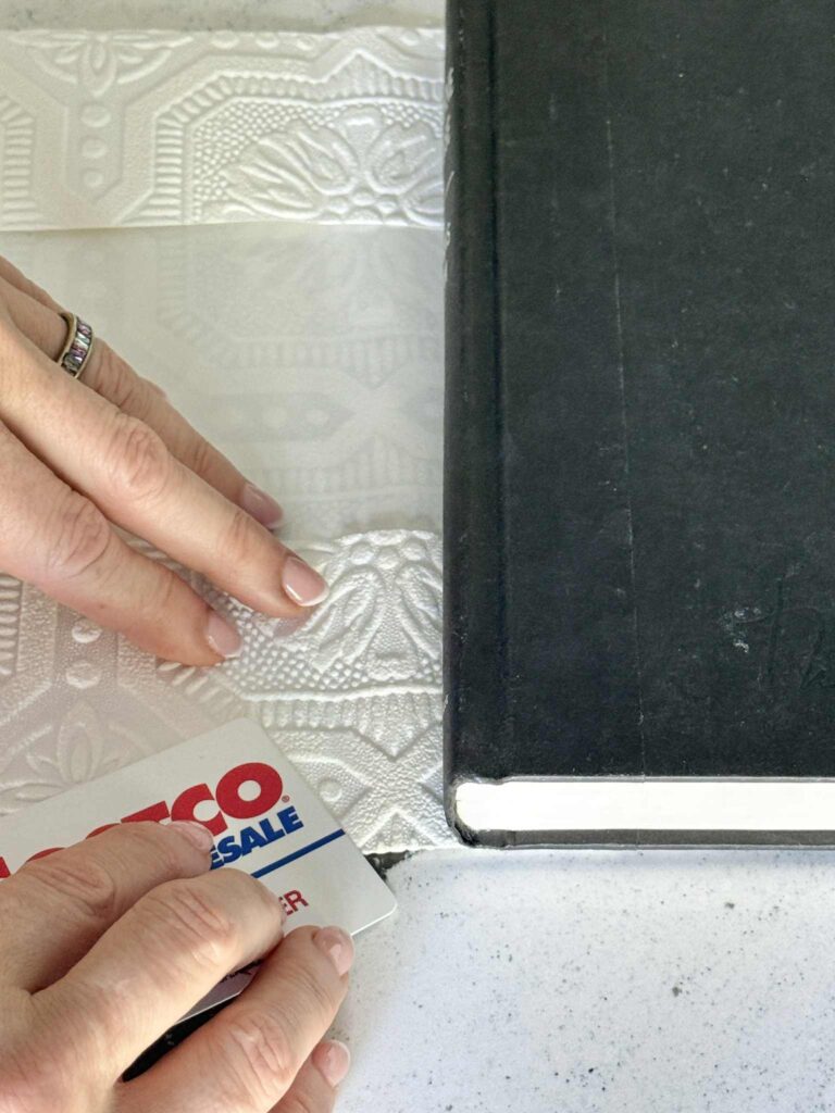 Pressing the crease in a DIY book cover.
