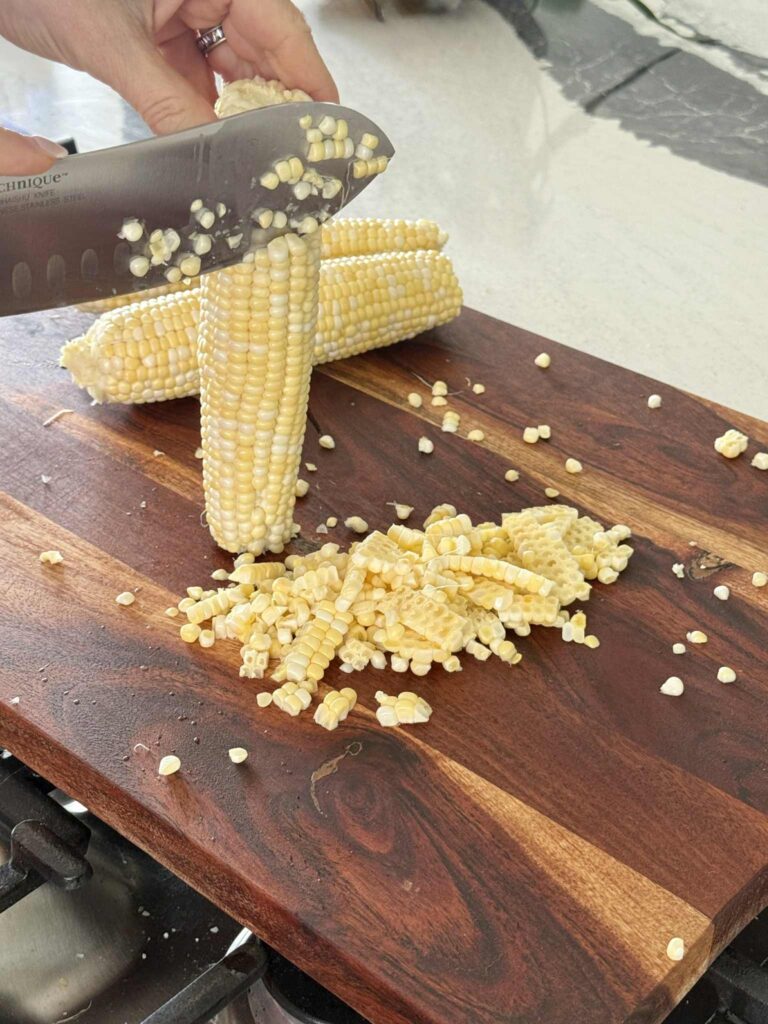 Cutting corn off the cob.