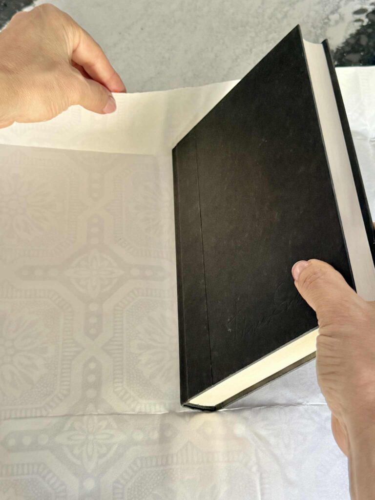 Centering a book on a piece of wallpaper for a diy book cover.