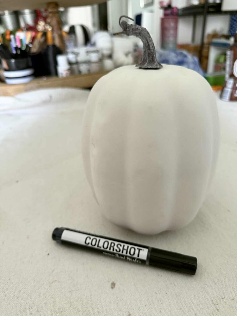 A white faux craft pumpkin.