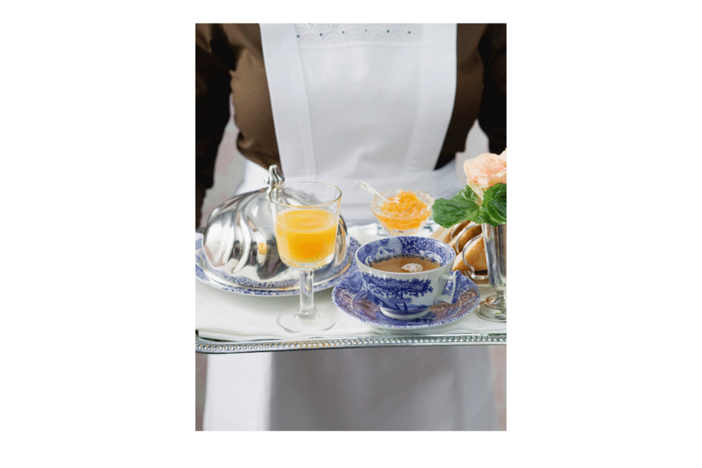 A breakfast tray with orange juice and tea.