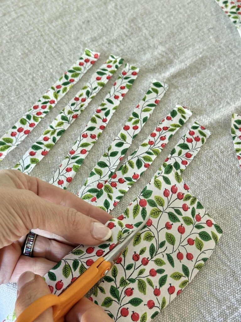 Cutting a paper napkin into strips.