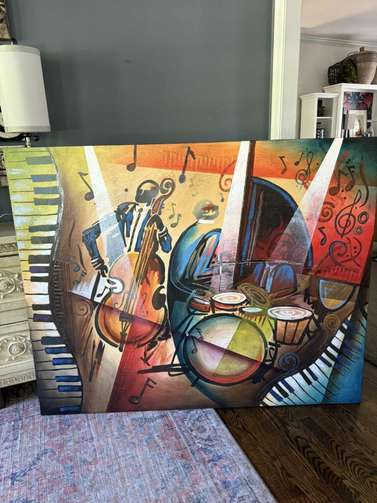 An old canvas art piece that is ripped and in need of repurposing.