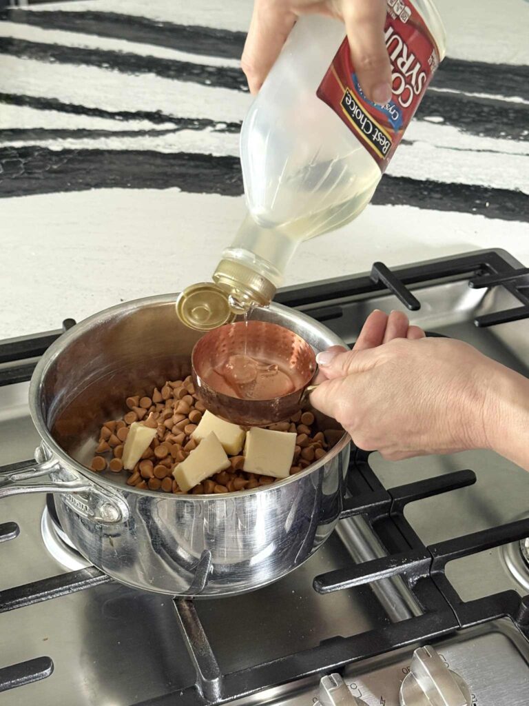 Pouring light corn syrup into a measuring cup.