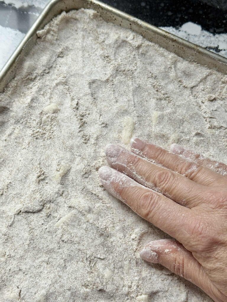 Press a flour mixture into a baking pan.