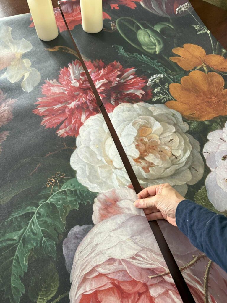 Two strips of wallpaper that are part of a wall mural used to repurpose wall art.