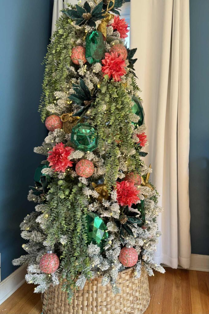 Decorating Ideas for a flocked Christmas tree: decorations in shades of coral, green, and coral.