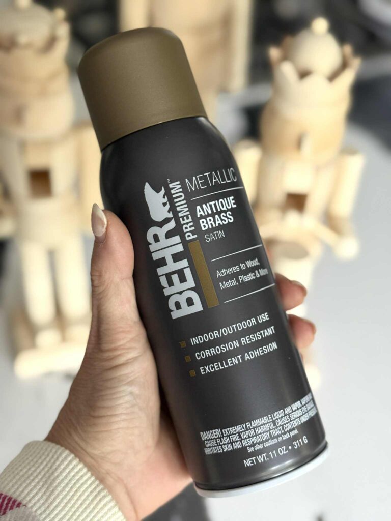 A can of Behr spray paint in Antique Brass satin.