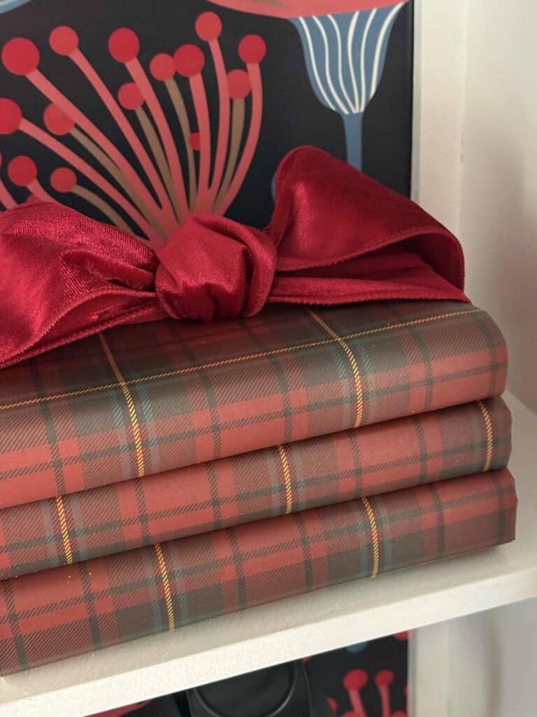 Books covered in red plaid paper for a Ralph Lauren Christmas aesthetic.