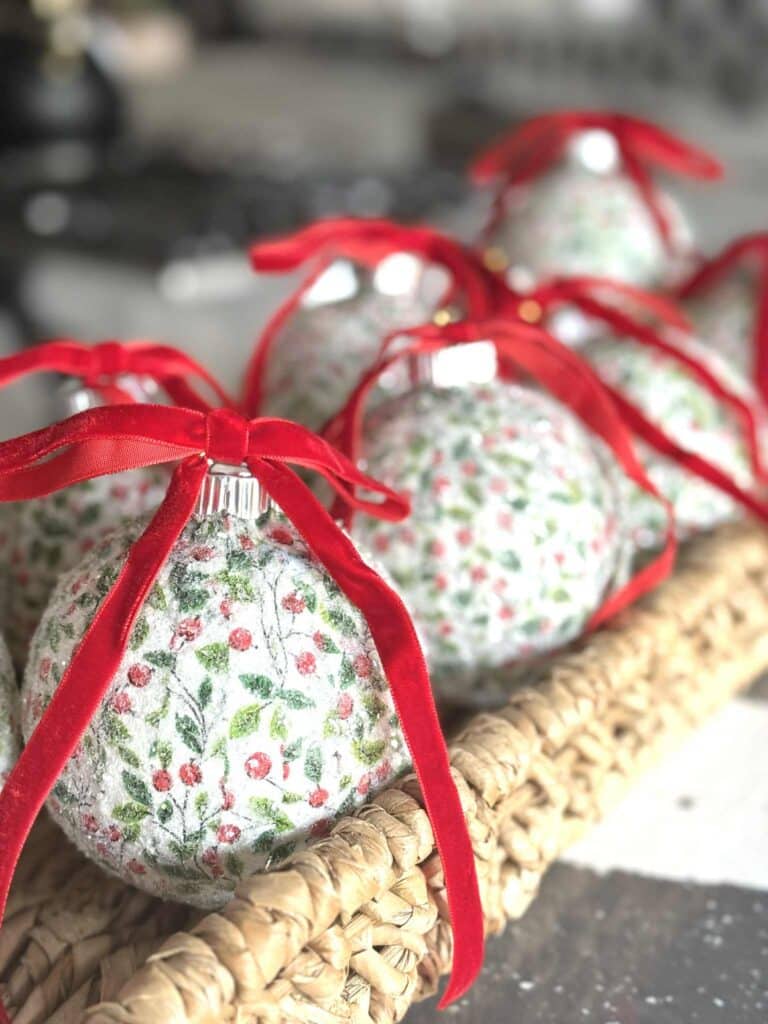 decoupage Christmas ornaments in a woven basket.