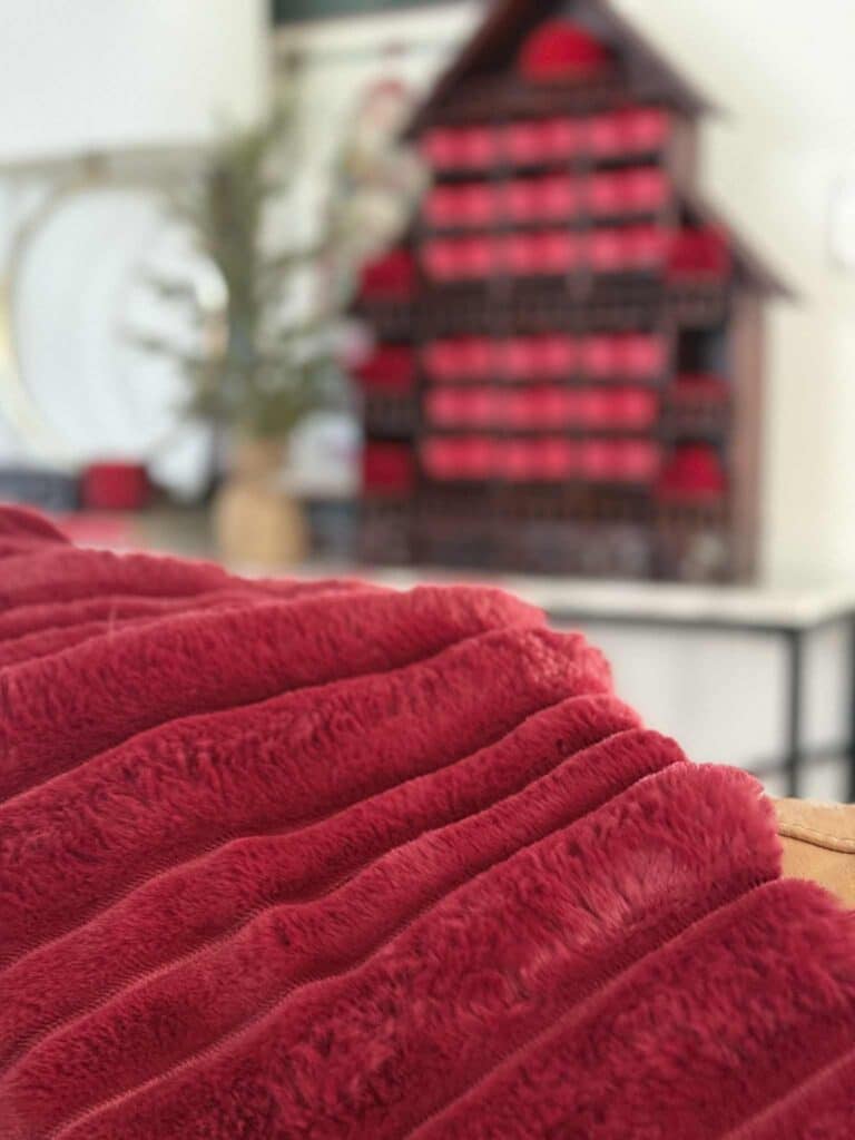 Burgundy red faux fur throw blanket for Christmas decorating.