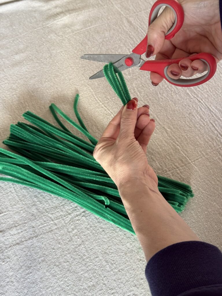 Cutting green pipe cleaners into fourths.