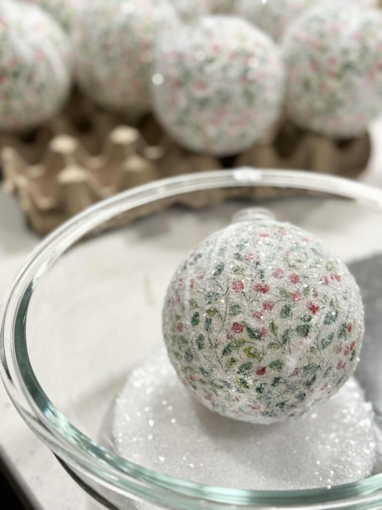 decoupage Christmas ornaments with sparkles on the outside.