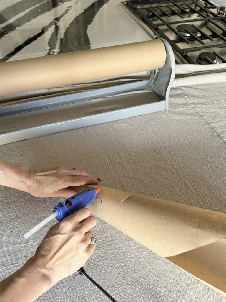 Gluing a paper cone for a diy pipe cleaner Christmas tree.