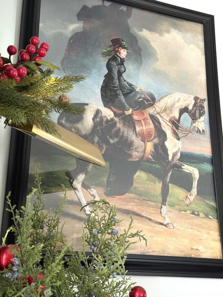 Wall art featuring a horsewoman.
